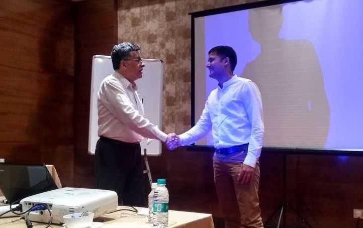 Univerve founder K.K. Moradian shaking hands with a client